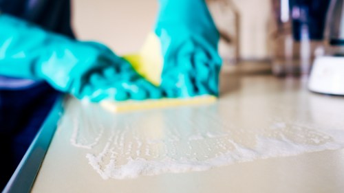 Commercial cleaning team disinfecting high-touch surfaces